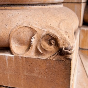 The head of a mouse looks out from the bottom of one of the pillars flanking the entrance.
