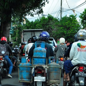 A scooter with gas bottles for delivery
